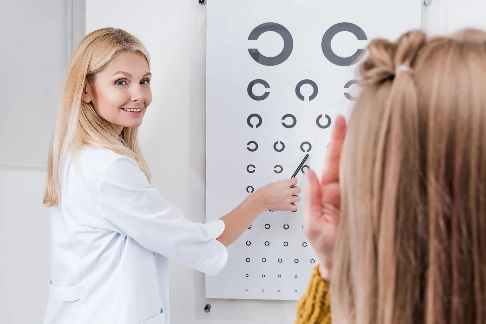 Patient doing an eye test with an eye chart